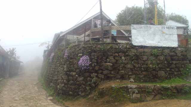 Gairibas with a rough poster showing direction to Nepal