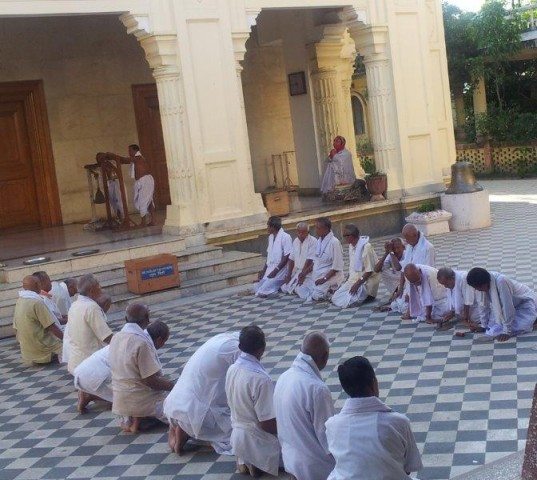 Devotee stands in parallel line for Puja