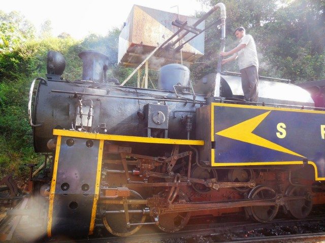 Assistant filling water in the locomotive