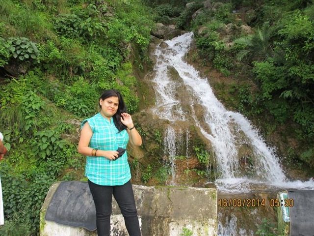 Feeling great in front of cascading falls